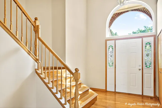 a view of staircase with railing and a potted plant