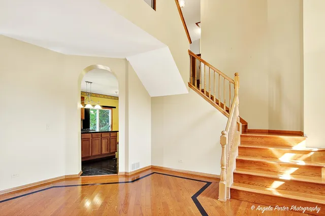 a view of an entryway with wooden floor and door