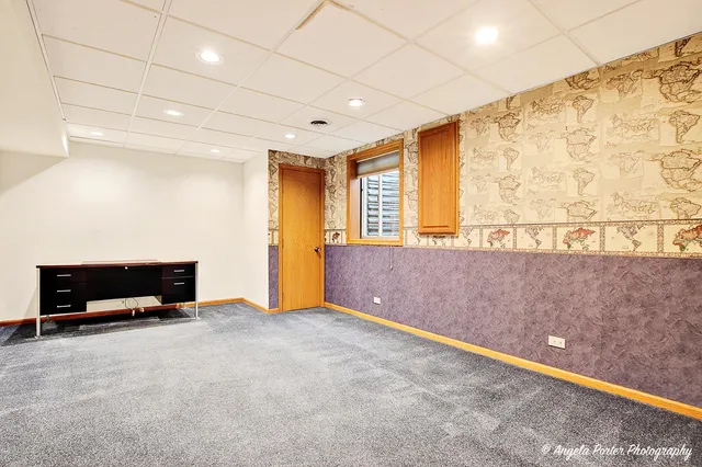 a view of a room with wooden walls and windows