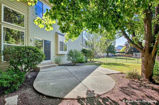 a swimming pool with outdoor seating and yard