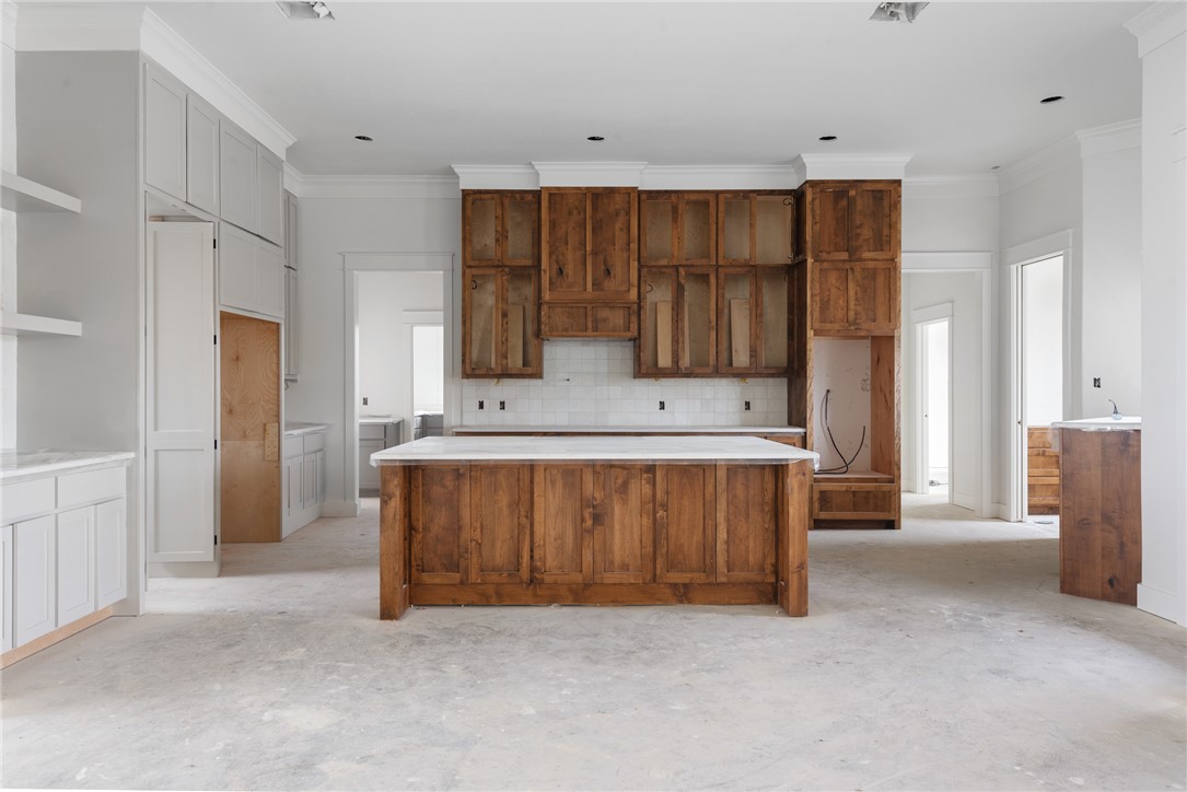 7873 Mathis Crk Drive Bryan, TX 77808 - Photo 5 of 14 a view of kitchen with stainless steel appliances kitchen island granite countertop a refrigerator and a sink
