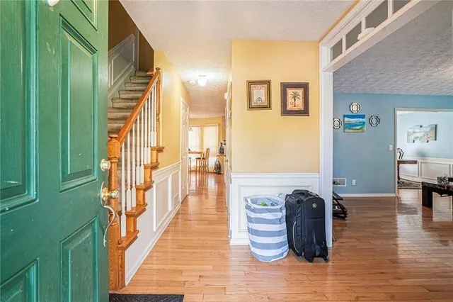 a view of an entryway with wooden floor