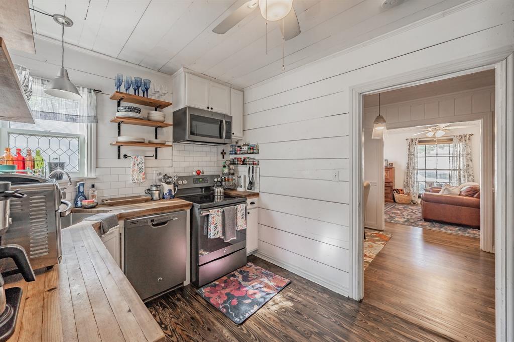 3516 Primrose Avenue Fort Worth, TX 76111 - Photo 14 of 30 a kitchen with stainless steel appliances granite countertop a stove and a refrigerator