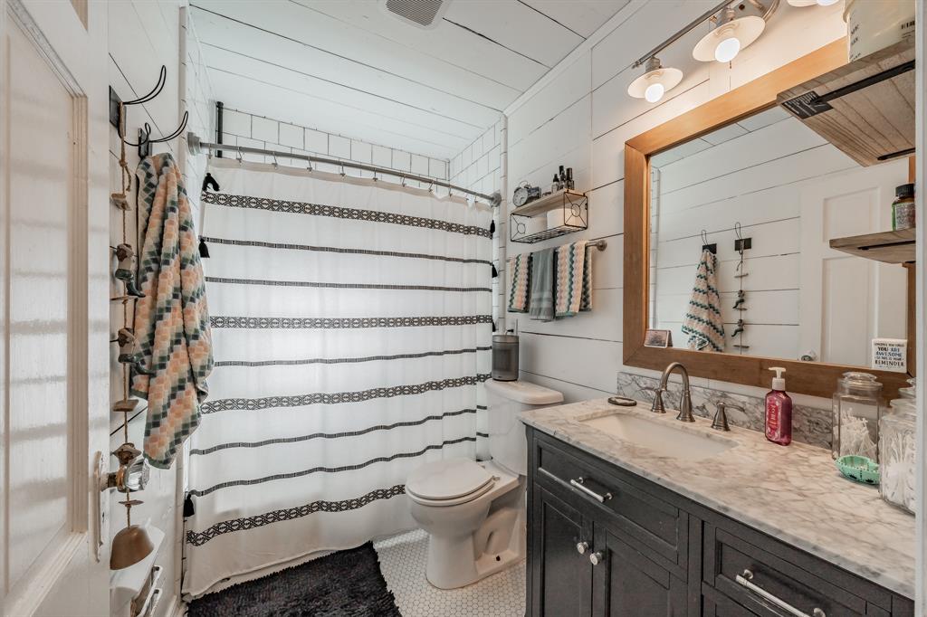 3516 Primrose Avenue Fort Worth, TX 76111 - Photo 22 of 30 a bathroom with a granite countertop sink toilet and shower