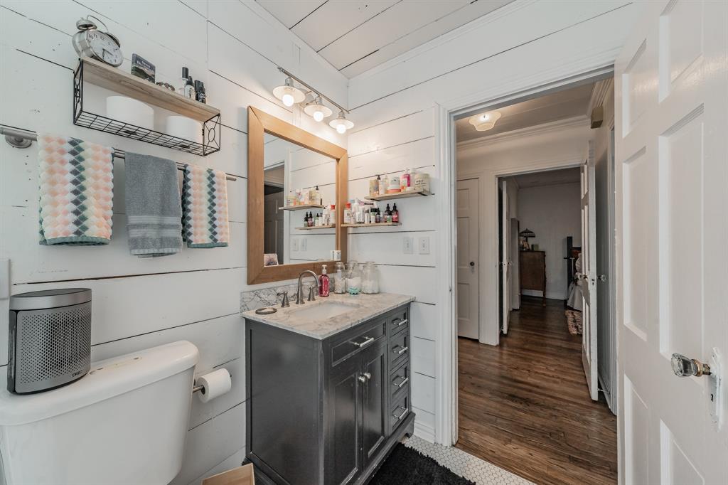 3516 Primrose Avenue Fort Worth, TX 76111 - Photo 24 of 30 a bathroom with a sink a toilet and mirror