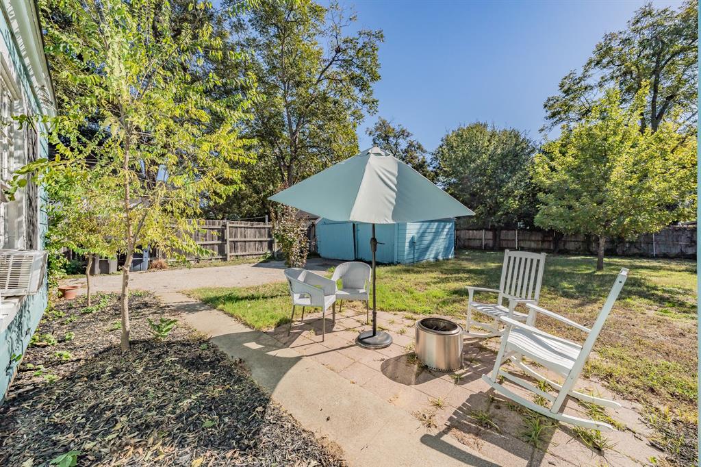 3516 Primrose Avenue Fort Worth, TX 76111 - Photo 27 of 30 a view of backyard with table and chairs potted plants and large tree