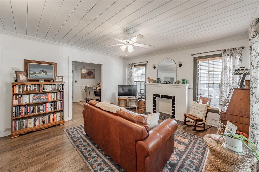 3516 Primrose Avenue Fort Worth, TX 76111 - Photo 5 of 30 a living room with furniture a fireplace and a book shelf