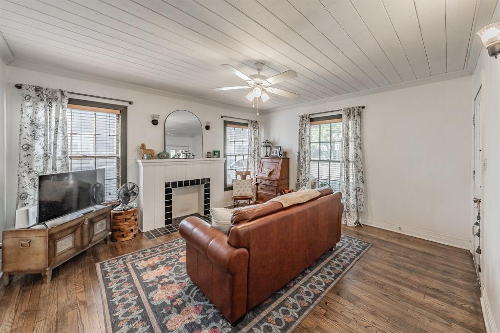 3516 Primrose Avenue Fort Worth, TX 76111 - Photo 6 of 30 a living room with furniture a flat screen tv and a fireplace