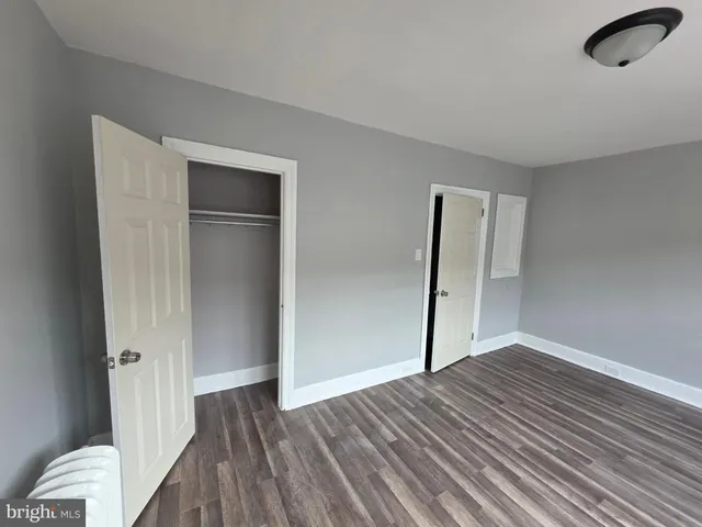 a view of a room with wooden floor and windows