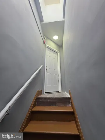 a kitchen with a refrigerator stove and wooden cabinets