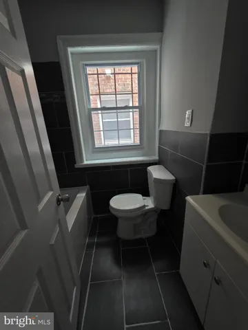 a kitchen with cabinets appliances a sink and a window
