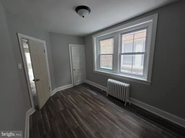 a front view of a building with parking space