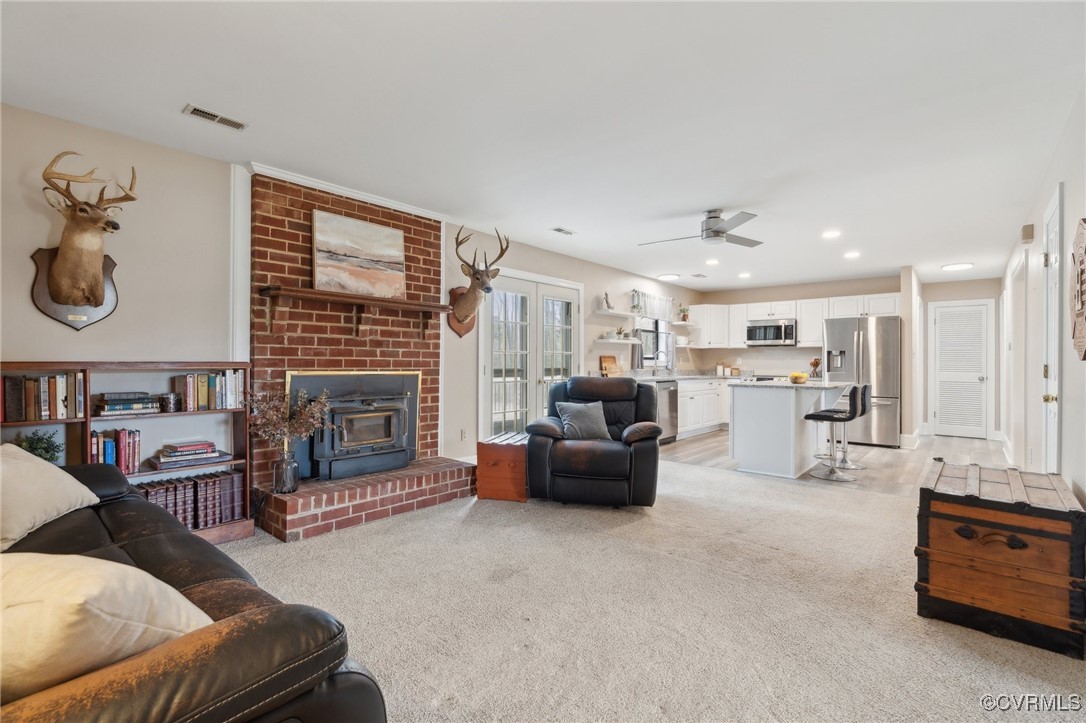 17830 Stage Road Barhamsville, VA 23011 - Photo 11 of 48 Living room with visible vents, a wood stove, ceil