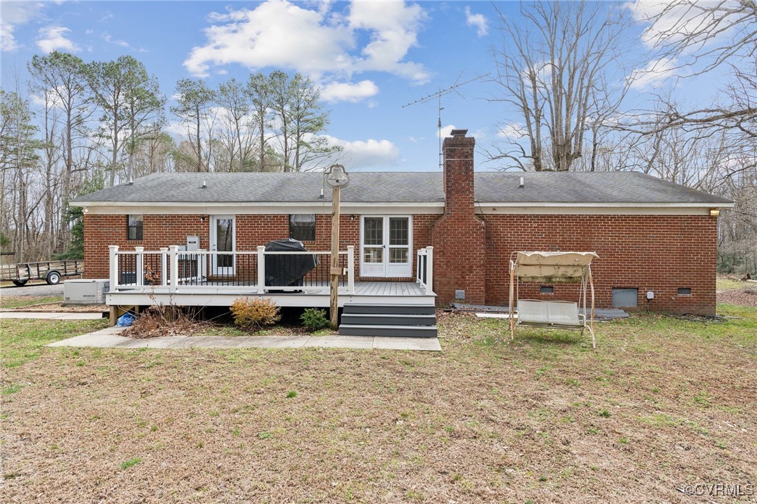 17830 Stage Road Barhamsville, VA 23011 - Photo 36 of 48 Rear view of house featuring a wooden deck, a lawn