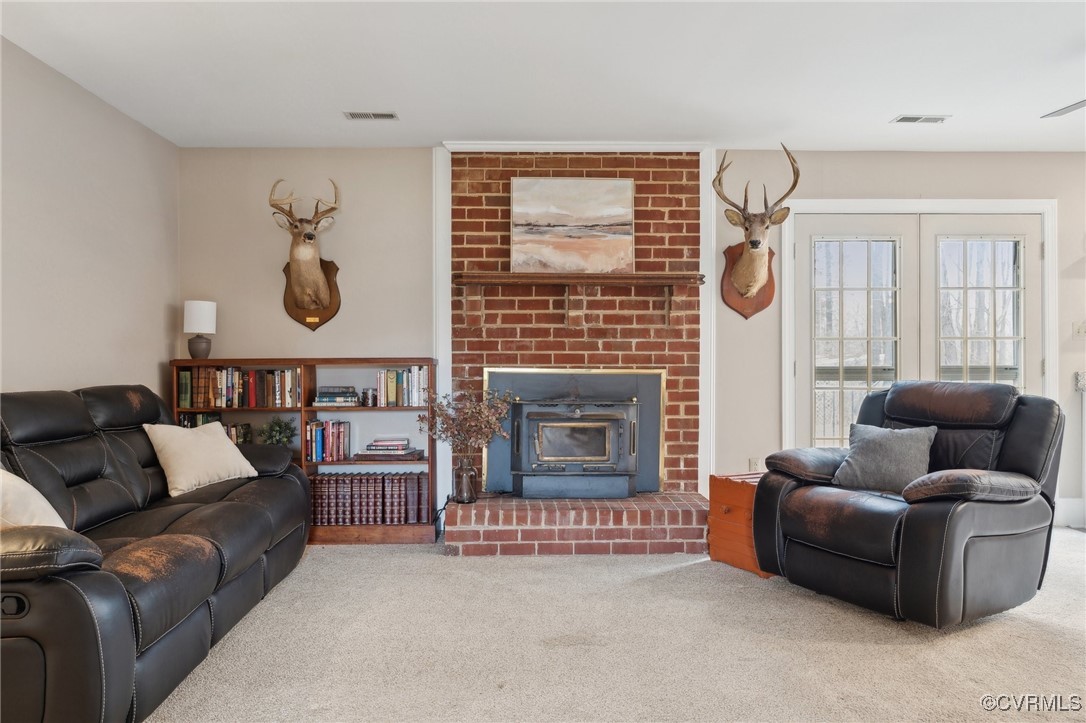 17830 Stage Road Barhamsville, VA 23011 - Photo 9 of 48 Carpeted living area featuring a fireplace, visibl