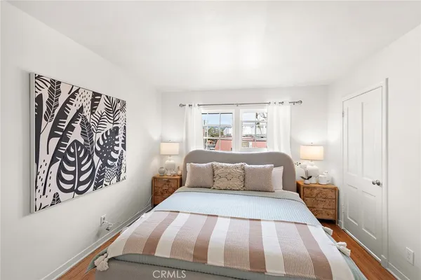a bedroom with a large bed and a window