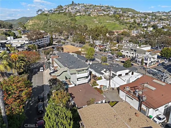 an aerial view of a city with lots of residential buildings and parking space