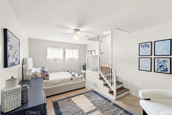 a bedroom with furniture and wooden floor