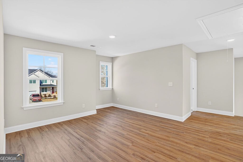 152 Classic Overlook Homer, GA 30547 - Photo 15 of 36 a view of an empty room with wooden floor and a window