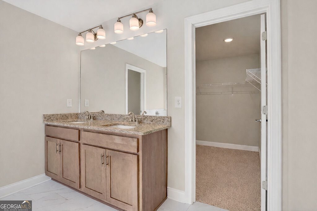 152 Classic Overlook Homer, GA 30547 - Photo 19 of 36 a bathroom with a granite countertop sink a large mirror and a vanity