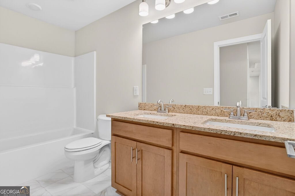 152 Classic Overlook Homer, GA 30547 - Photo 28 of 36 a bathroom with a granite countertop sink a toilet and a bathtub