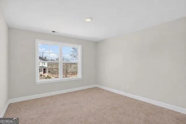 a view of an empty room and closet area