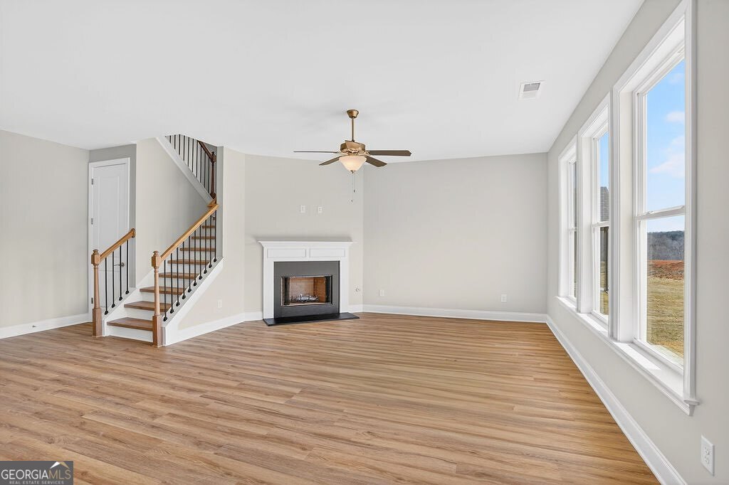 152 Classic Overlook Homer, GA 30547 - Photo 5 of 36 a view of an empty room with wooden floor fireplace and a window