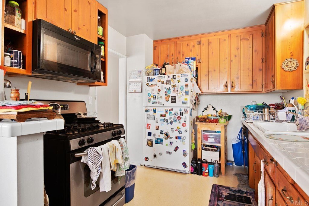 3255 Canyon Street Carlsbad, CA 92008 - Photo 17 of 33 a kitchen with stainless steel appliances a stove a sink and a microwave