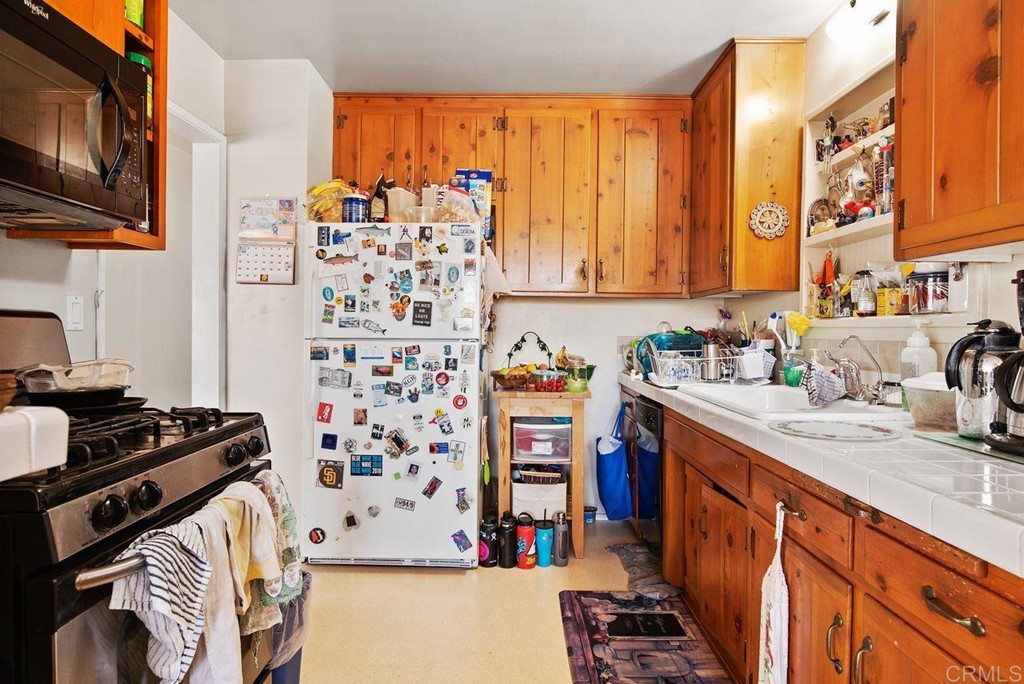 3255 Canyon Street Carlsbad, CA 92008 - Photo 18 of 33 a kitchen with stainless steel appliances granite countertop a stove and a sink