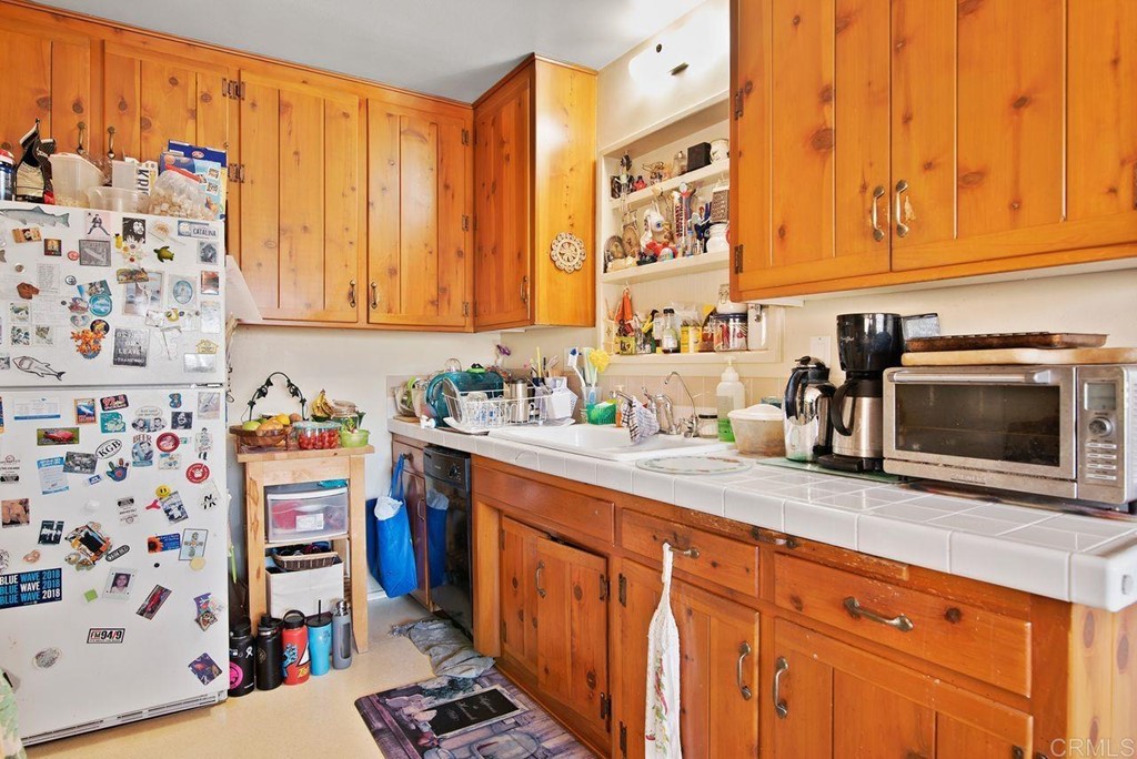 3255 Canyon Street Carlsbad, CA 92008 - Photo 19 of 33 a kitchen with stainless steel appliances granite countertop a sink and a microwave