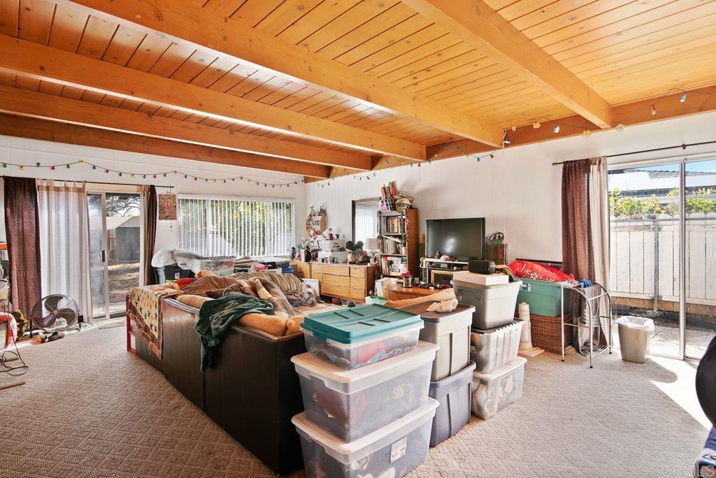 3255 Canyon Street Carlsbad, CA 92008 - Photo 23 of 33 a living room with lots of furniture and a flat screen tv