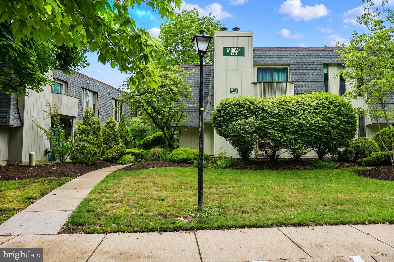 25 South Church Road, Unit 52 Maple Shade, NJ 08052 - Photo 1 of 10 a front view of a house with a garden