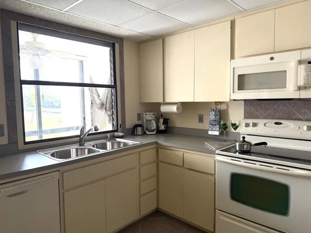 a kitchen with stainless steel appliances white cabinets and a sink