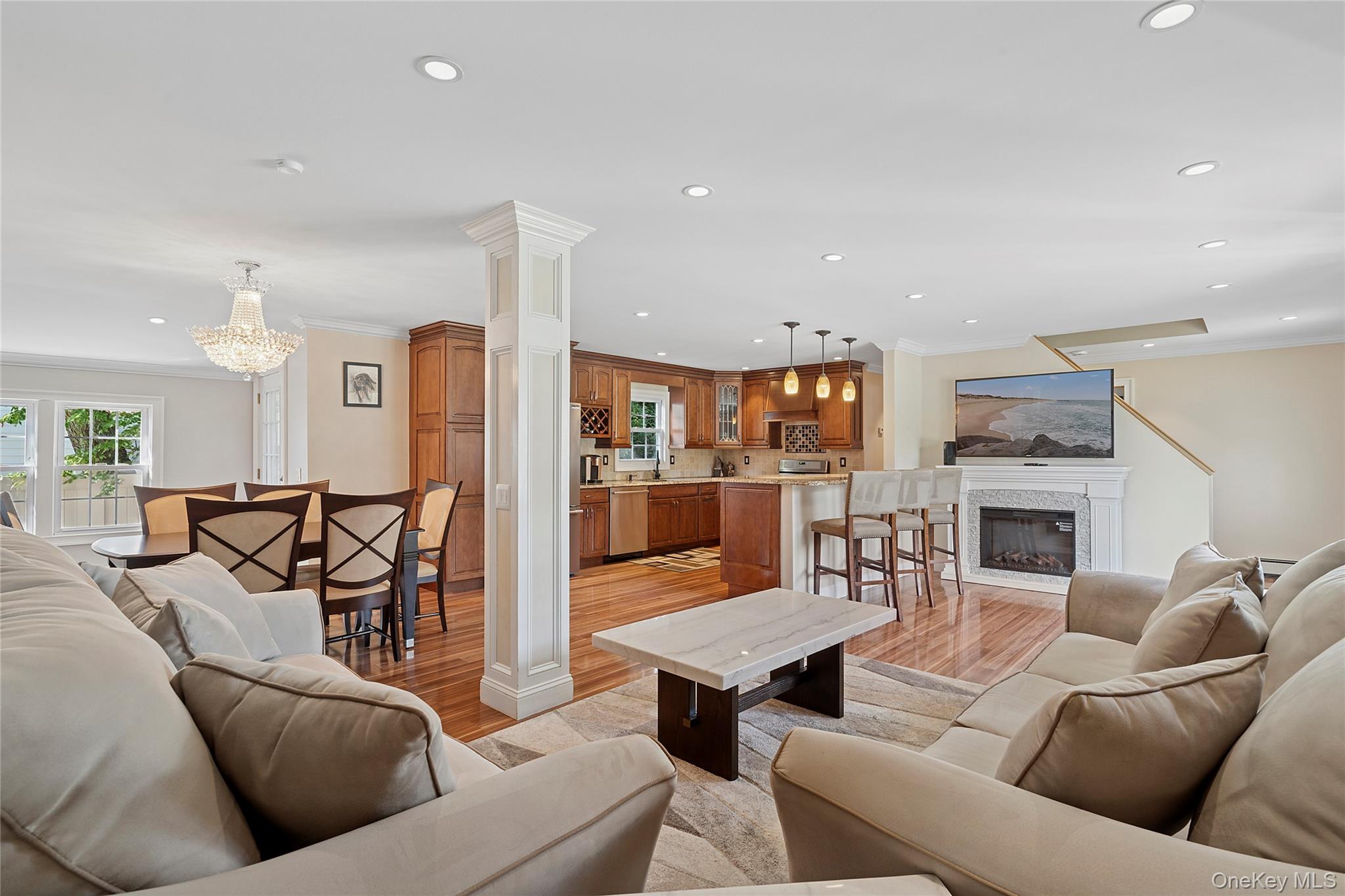 2 Ross Road Babylon, NY 11702 - Photo 1 of 1 a living room with furniture a fireplace and a kitchen view