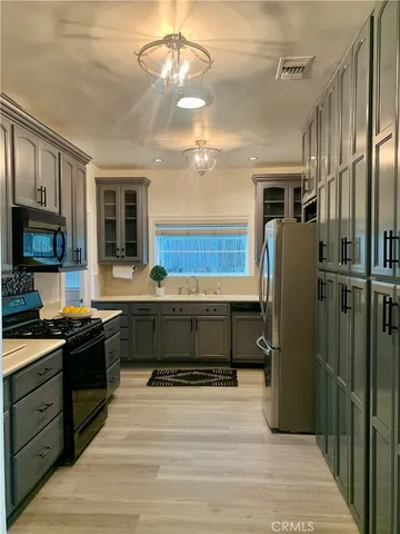 a view of a refrigerator in kitchen and wooden floor