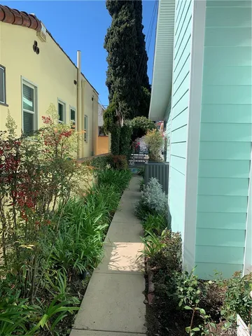 a view of a swimming pool with lawn chairs under an umbrella