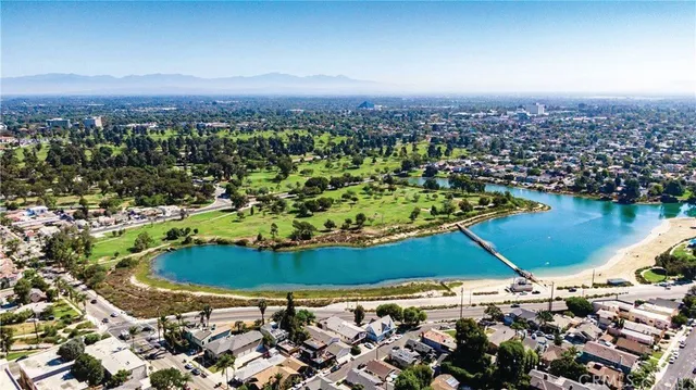 a front view of a house with a yard and potted plants