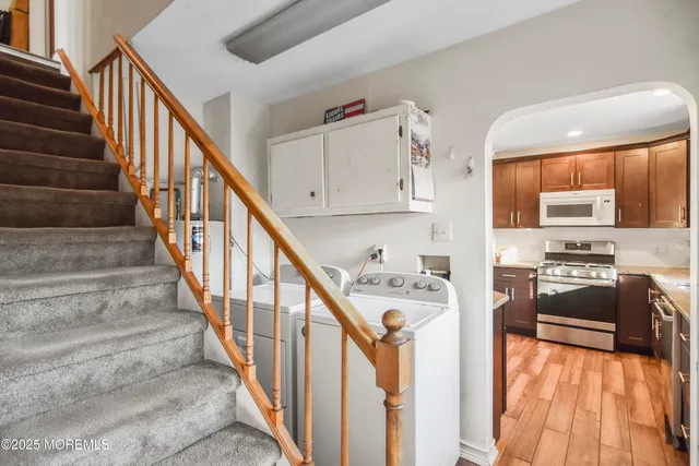 a view of a kitchen with furniture and electronic appliances