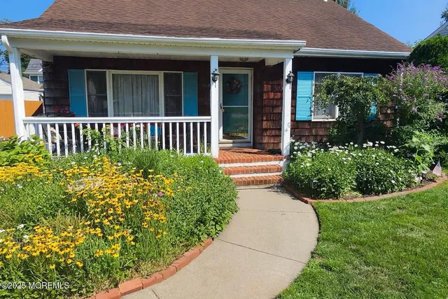 a view of a house with potted plants