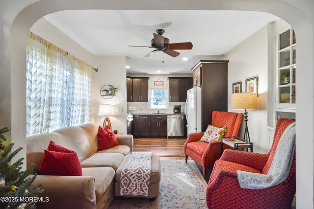 a living room with furniture a rug and a large window