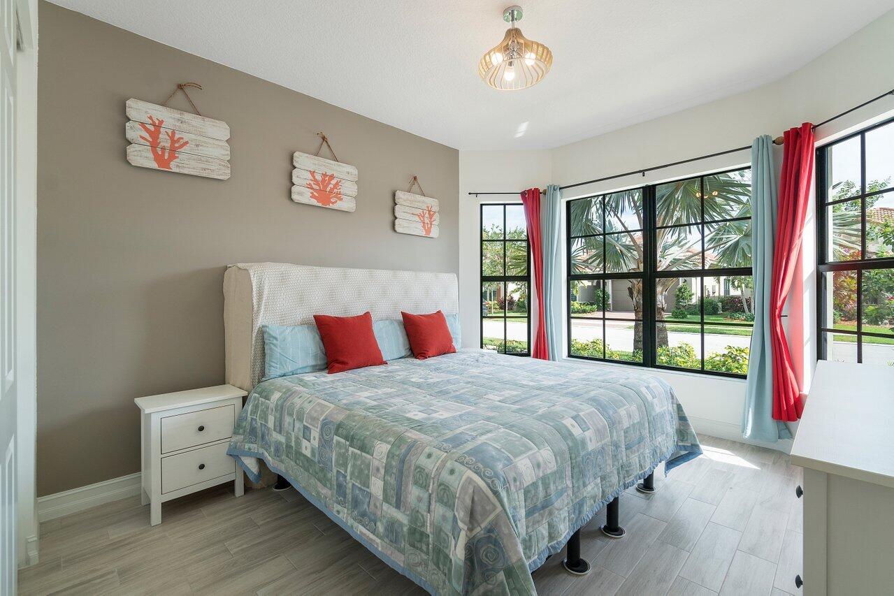 11856 Leon Circle Parkland, FL 33076 - Photo 13 of 43 a bedroom with a bed and a large window