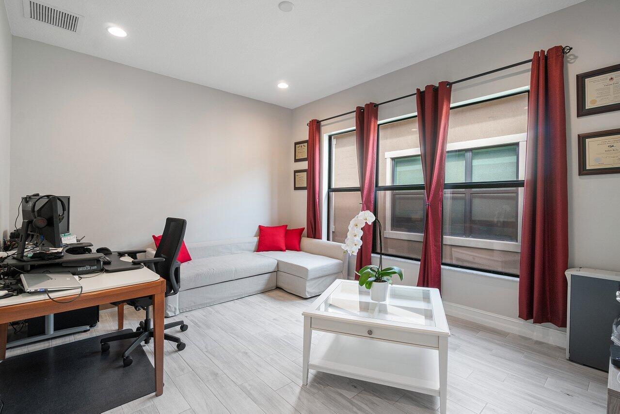 11856 Leon Circle Parkland, FL 33076 - Photo 16 of 43 a living room with furniture and a window
