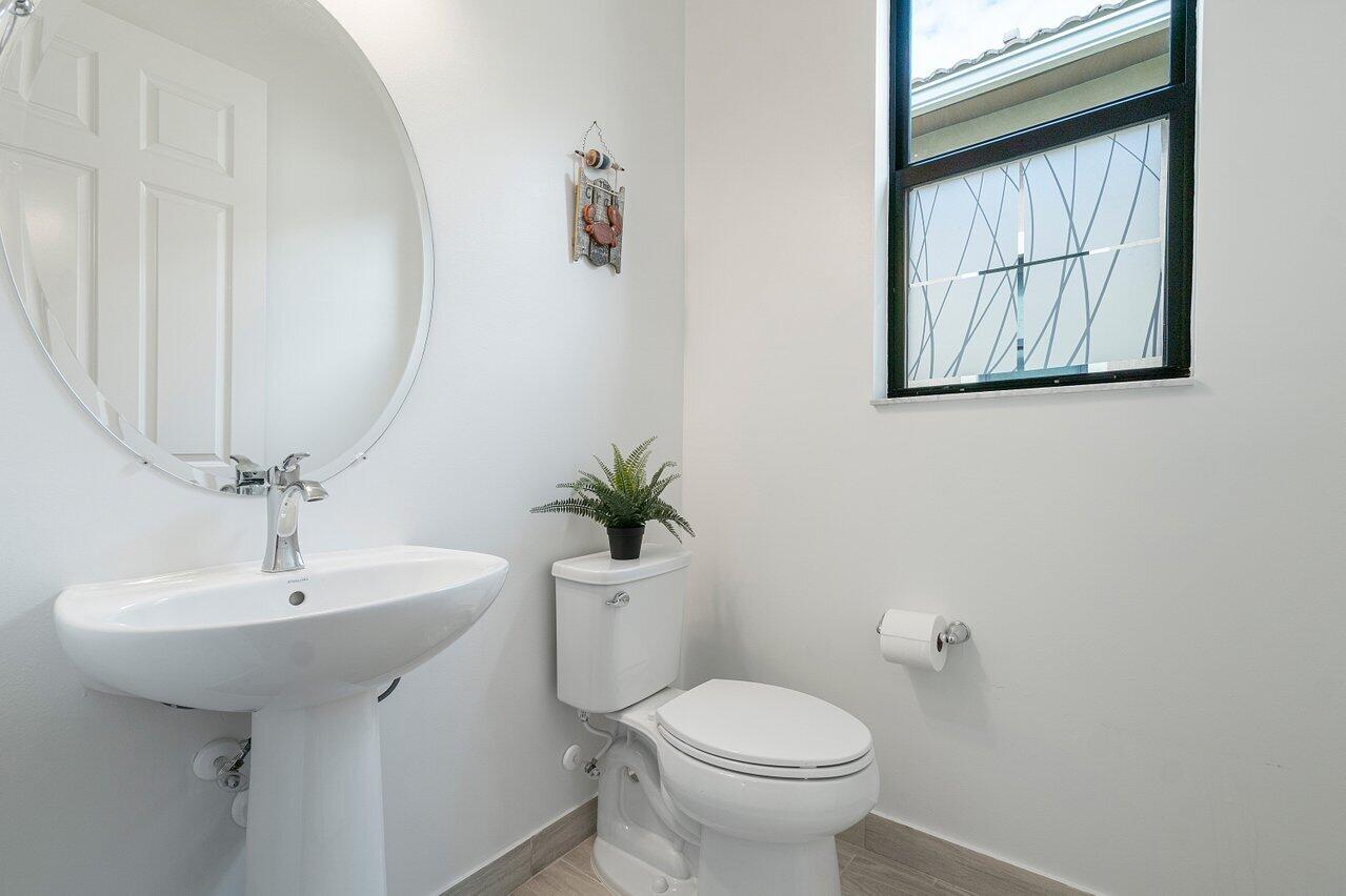 11856 Leon Circle Parkland, FL 33076 - Photo 17 of 43 a bathroom with a sink toilet and mirror