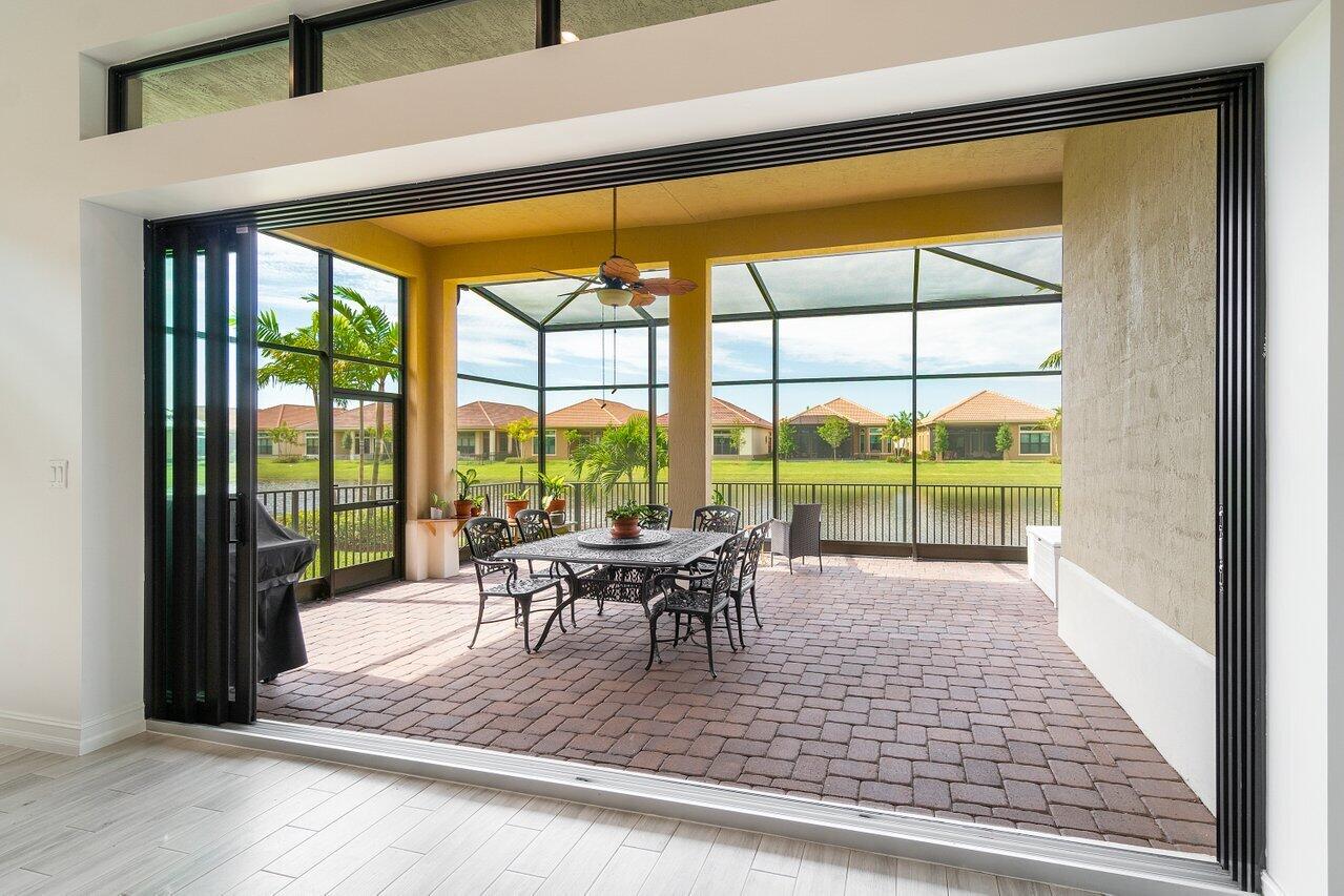 11856 Leon Circle Parkland, FL 33076 - Photo 20 of 43 a view of a living room with furniture and floor to ceiling windows