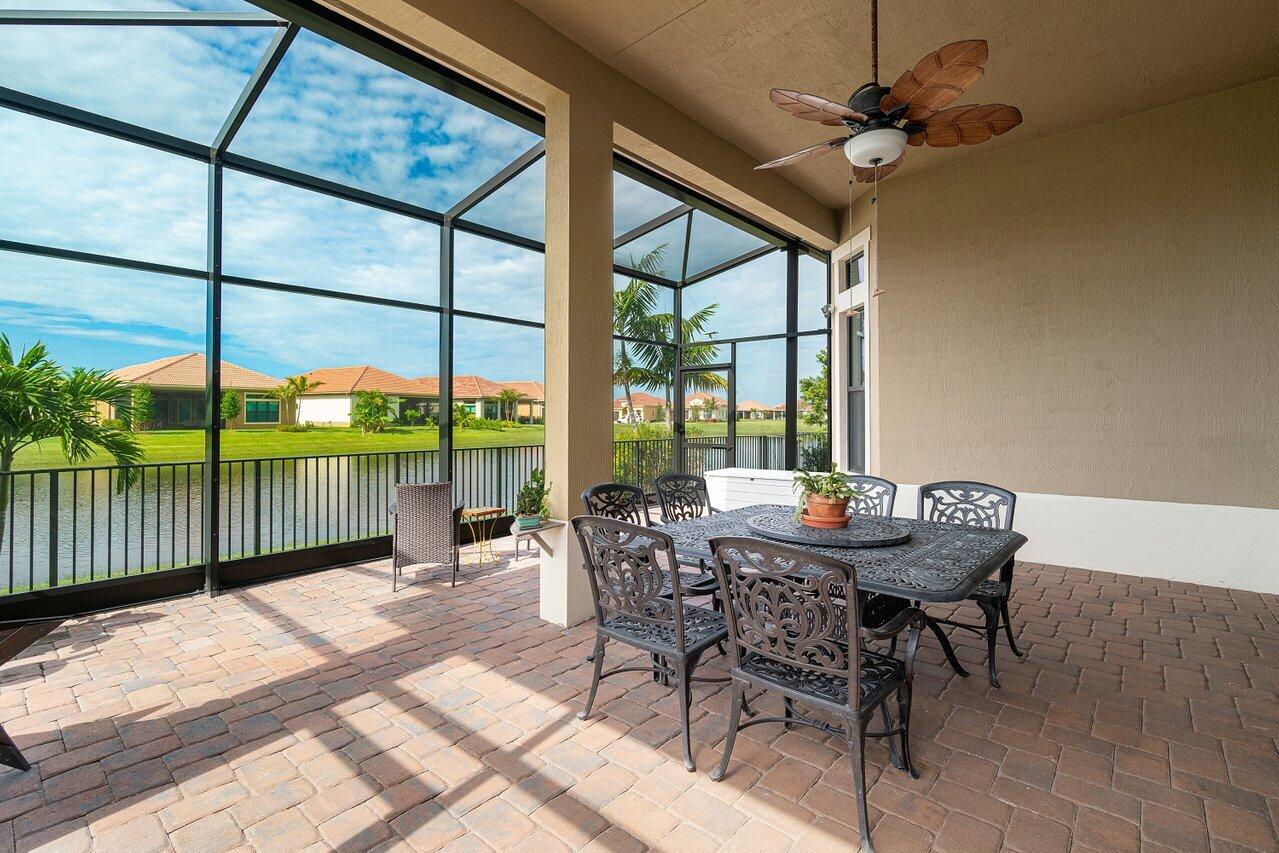 11856 Leon Circle Parkland, FL 33076 - Photo 22 of 43 a dining room with furniture water view and a floor to ceiling window