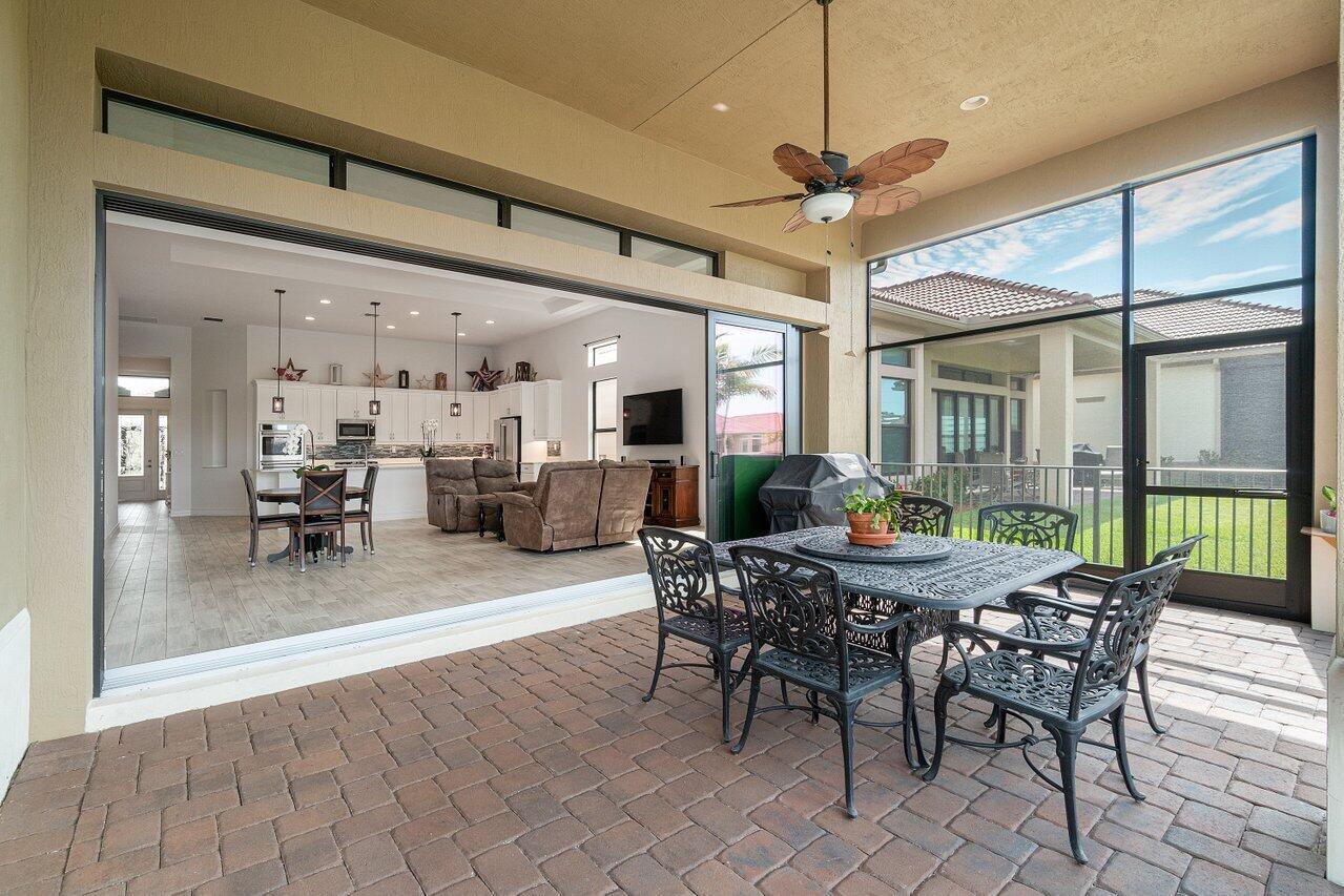 11856 Leon Circle Parkland, FL 33076 - Photo 23 of 43 a dining room with furniture a chandelier and wooden floor