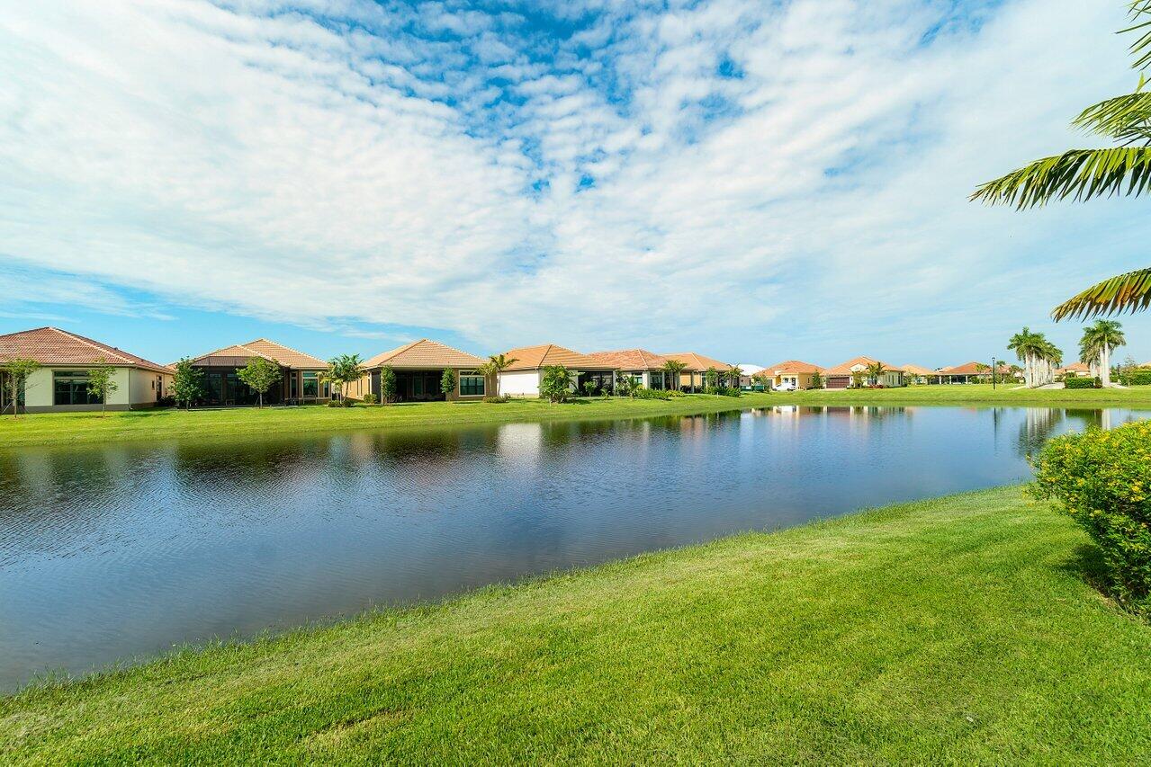 11856 Leon Circle Parkland, FL 33076 - Photo 26 of 43 a view of a lake with houses in the back