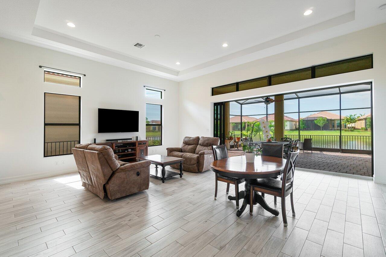 11856 Leon Circle Parkland, FL 33076 - Photo 3 of 43 a living room with furniture and a flat screen tv