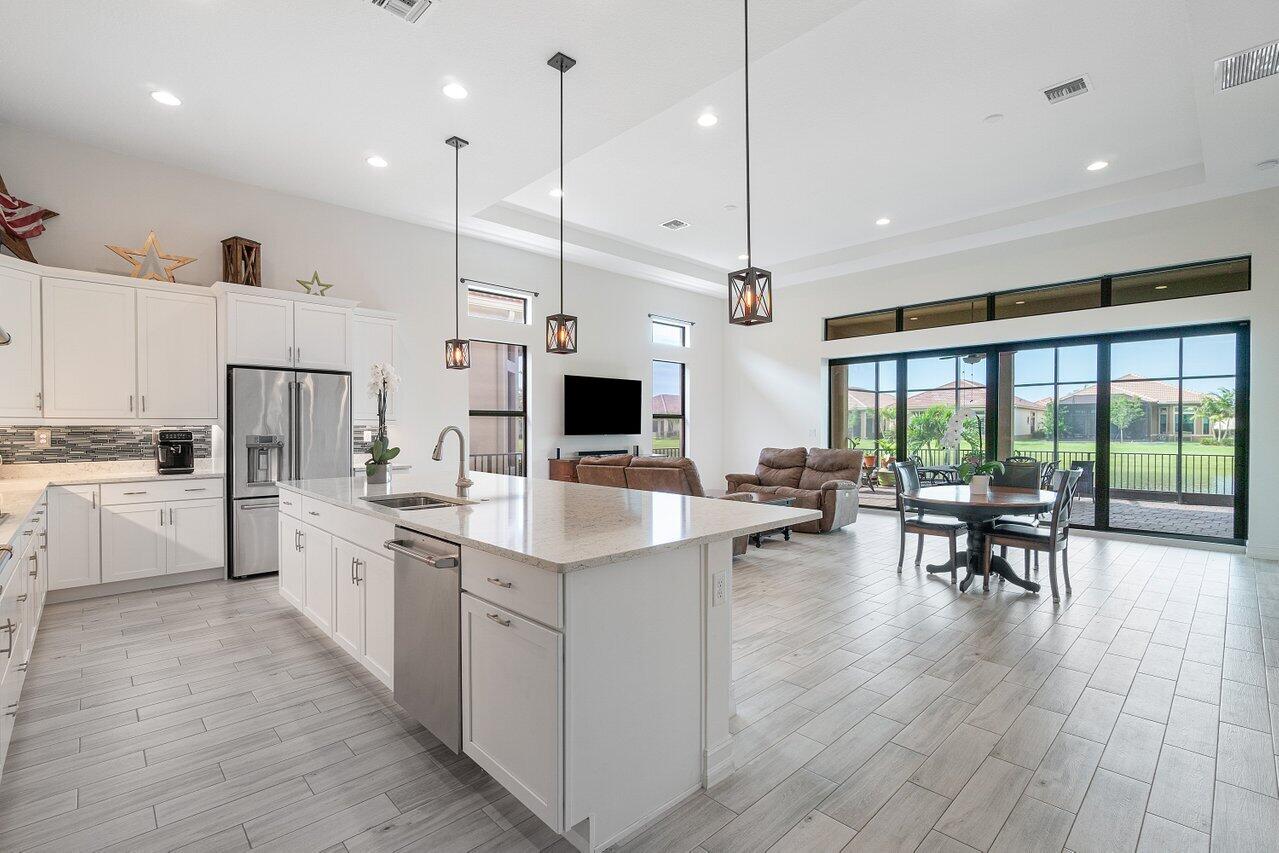 11856 Leon Circle Parkland, FL 33076 - Photo 6 of 43 a large kitchen with kitchen island a large center island in it