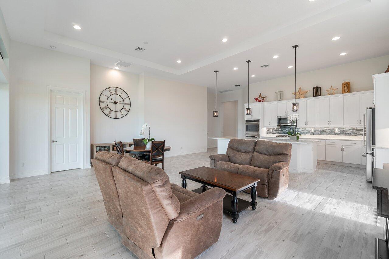 11856 Leon Circle Parkland, FL 33076 - Photo 7 of 43 a living room with furniture kitchen area and a view